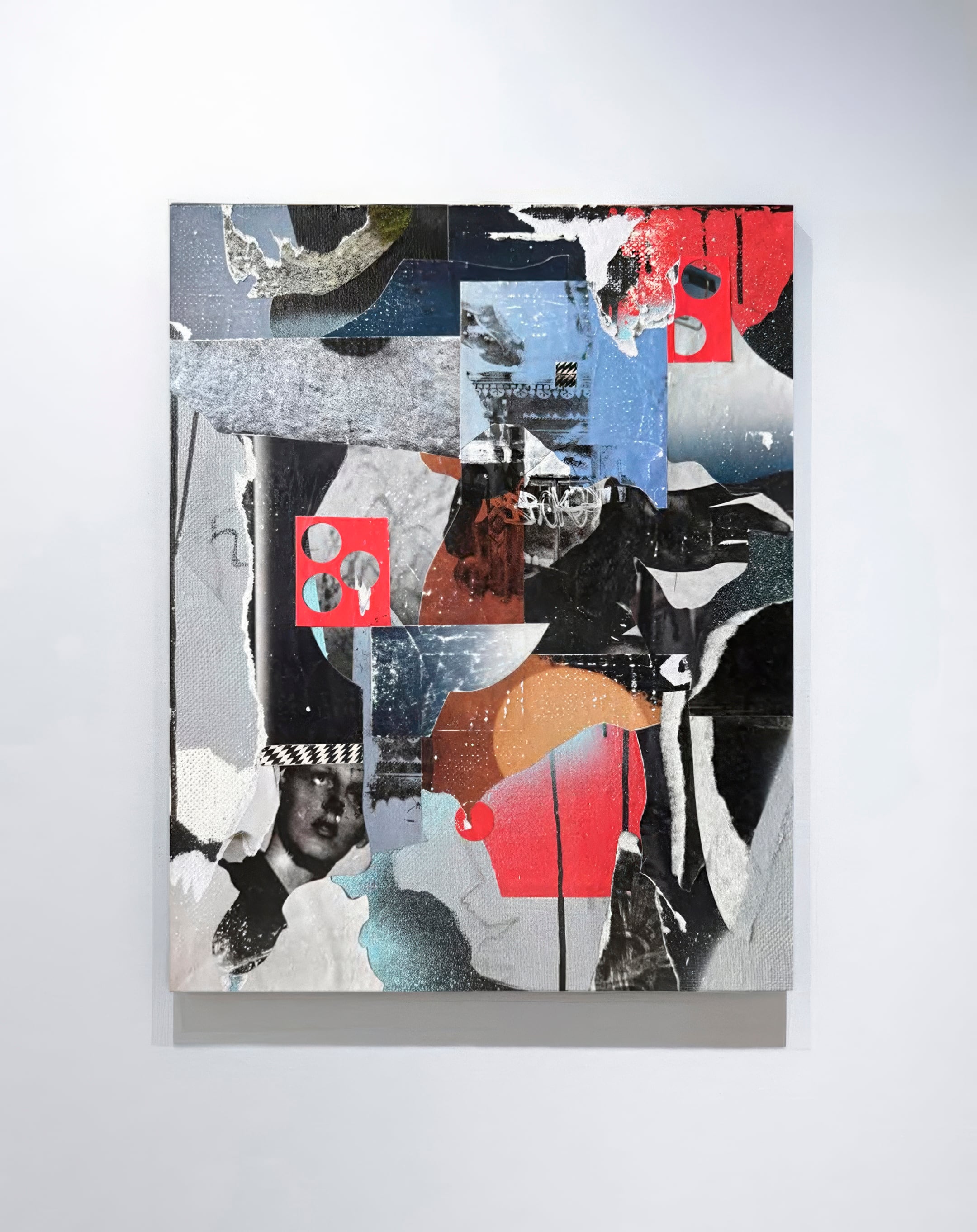 Abstract mixed-media collage in black, grey and blue with a red polka-dot circle, striped boots and fragments of striped fabric and foil