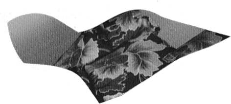 Torn paper cutout of draped fabric with a floral pattern