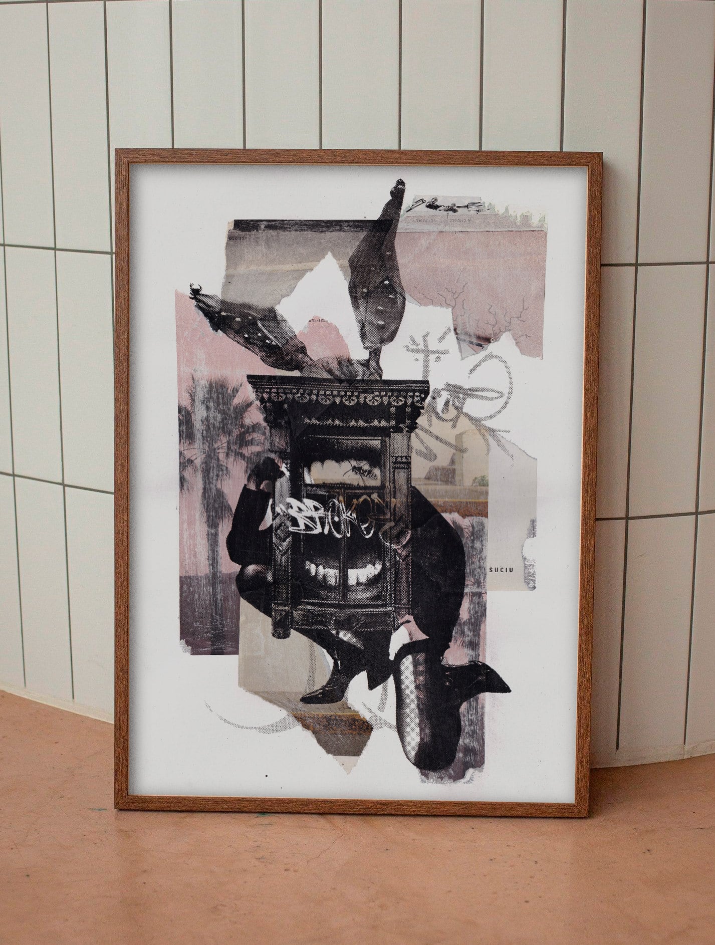 Framed print of the rabbit-cabinet artwork leaning against a tiled wall